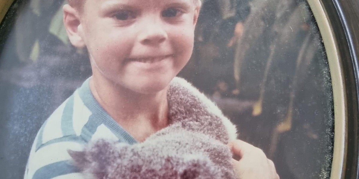 4 year old Greg holds a koala