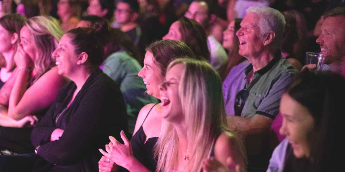 Audience members laughing uncontrollably during Comedy Hypnotist Matt Hale's 80s themed comedy hypnosis show Top Fun at Adelaide Fringe Festival