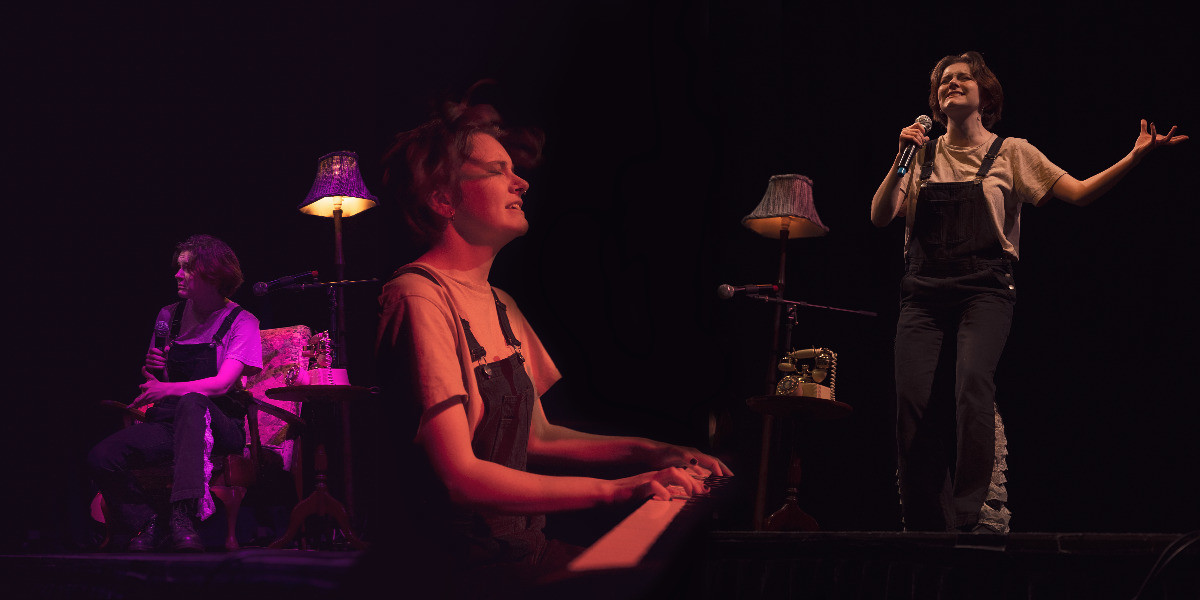 A collage of three other images. The left image shows Grace, a thin, white person with short brown hair sitting on a fabric chair onstage during a performance. To the right of the chair is a wooden side-table with an old-style rotary phone on it, a microphone stand and microphone on it, and a floor lamp with a fabric lampshade glowing a warm yellow and purple. Grace looks off to the left while holding another microphone in their right hand. They gesture to the audience with their left hand. A saturated pink light illuminates everything onstage.
In the middle image, Grace is playing the piano. They are wearing a white t-shirt and black overalls. Their eyes are closed and their hair is flowing as they are mid-performing. They are lit with a peach coloured light.
In the right image, Grace is mid-performing on-stage, holding a microphone in their right hand. They are lit with natural light and the lamp, microphone and stand, and side-table with the rotary phone on it are all to their right, on the stage. With their left arm, they hold it out to their side with their hand open as if they are holding something.