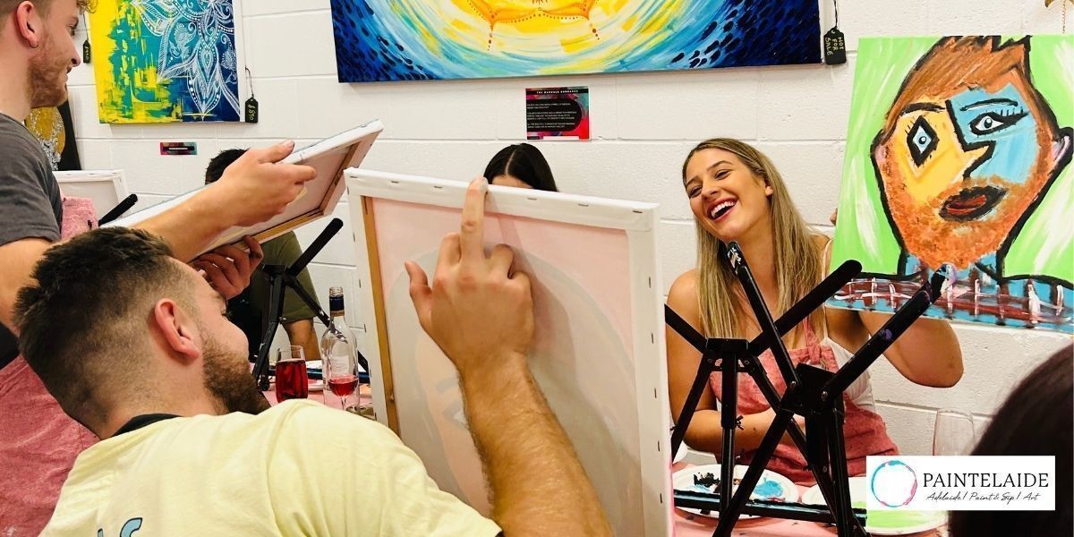 Couple revealing their finished artwork to each other and enjoying at Paintelaide Studio