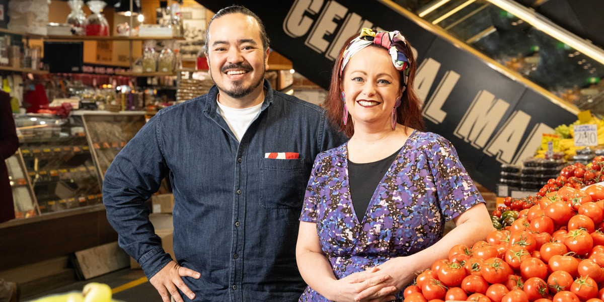 Adelaide Central Market Audio Tour - Adam Liaw and Katie Spain stand amongst produce at the Adelaide Central Market