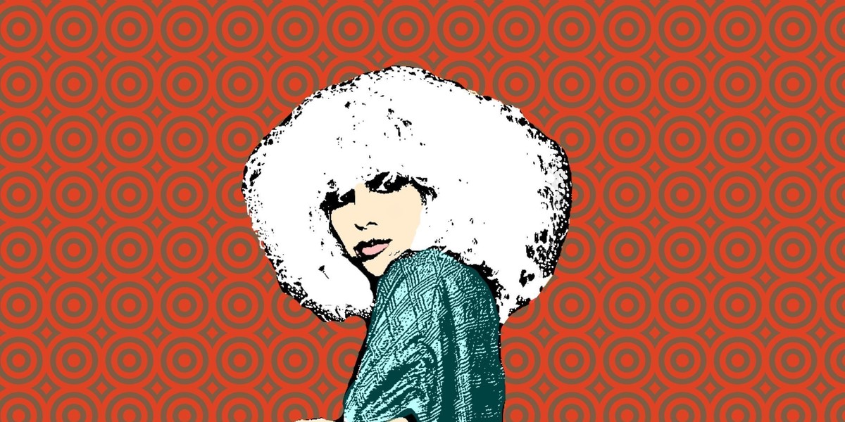 Girl with large hair on a red background looking at the camera