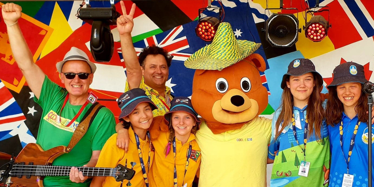 Nige is holding his bass guitar and Tony is wearing his bright yellow music note shirt. Cool Bear is our much loved mascot and he is visited by some excited audience members