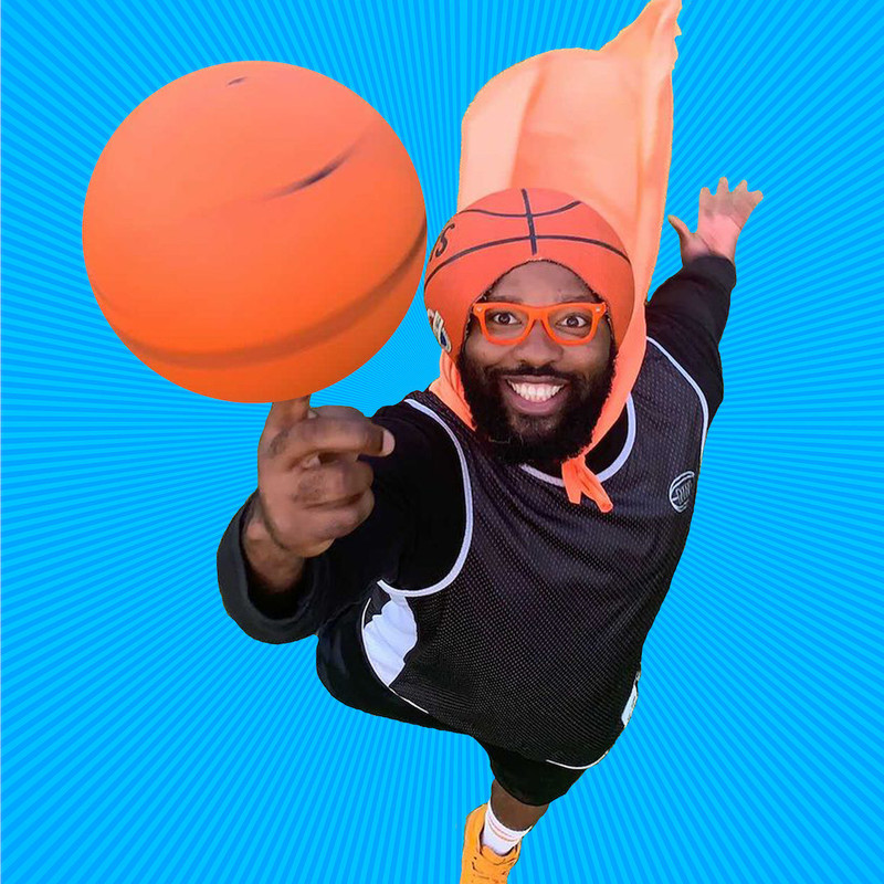 BasketballMan Can Fly - A man wearing a basketball cut into a helmet on his head spinning a basketball.