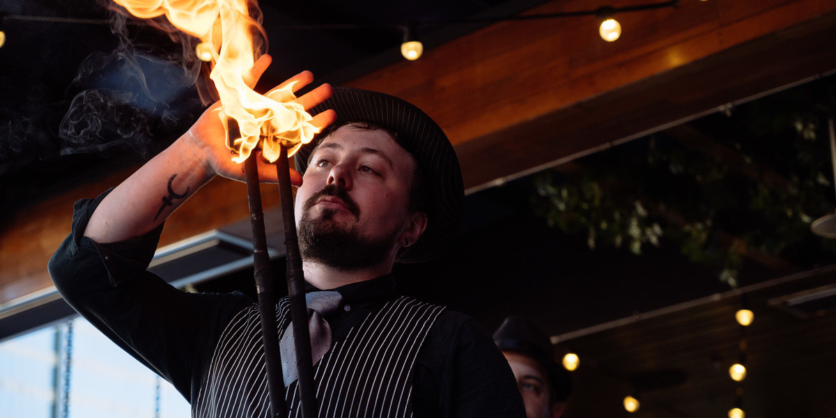 a fire performer caresses a ball of flame