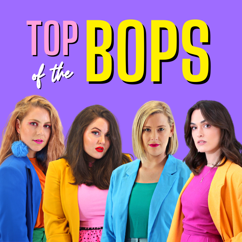 Top of the Bops - A bright purple background surrounds the pink, white and yellow words: Top of the Bops. Top is pink with yellow lining, Bops is yellow with pink lining and 'of the' is white with black lining. Underneath teh words are four female cast menbers wearing very bright and varied colourful jackets