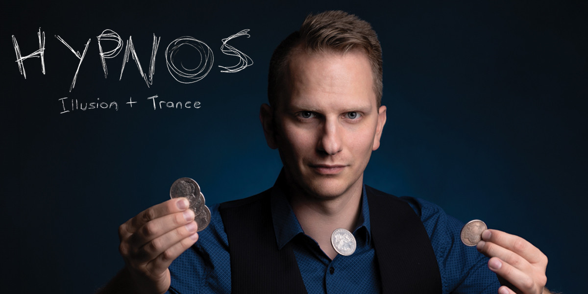 Hypnos - Rob is stood in front of a dark background holding coins. The image reads 'Hypnos - Illusion + Trance'