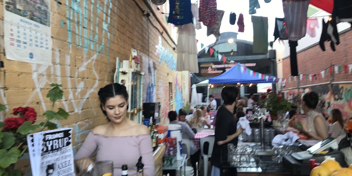 people populating a bar in rundle st laneway