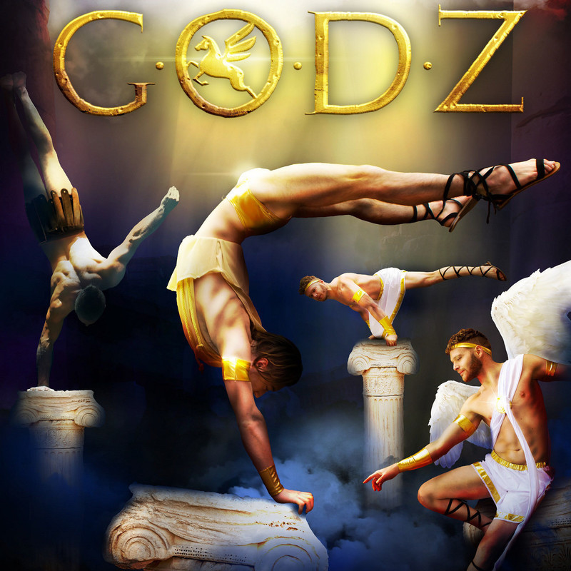 4 gods posing in different acrobatic positions beneath the word GODZ They are in colourful and bright costumes with a golden tinge.
