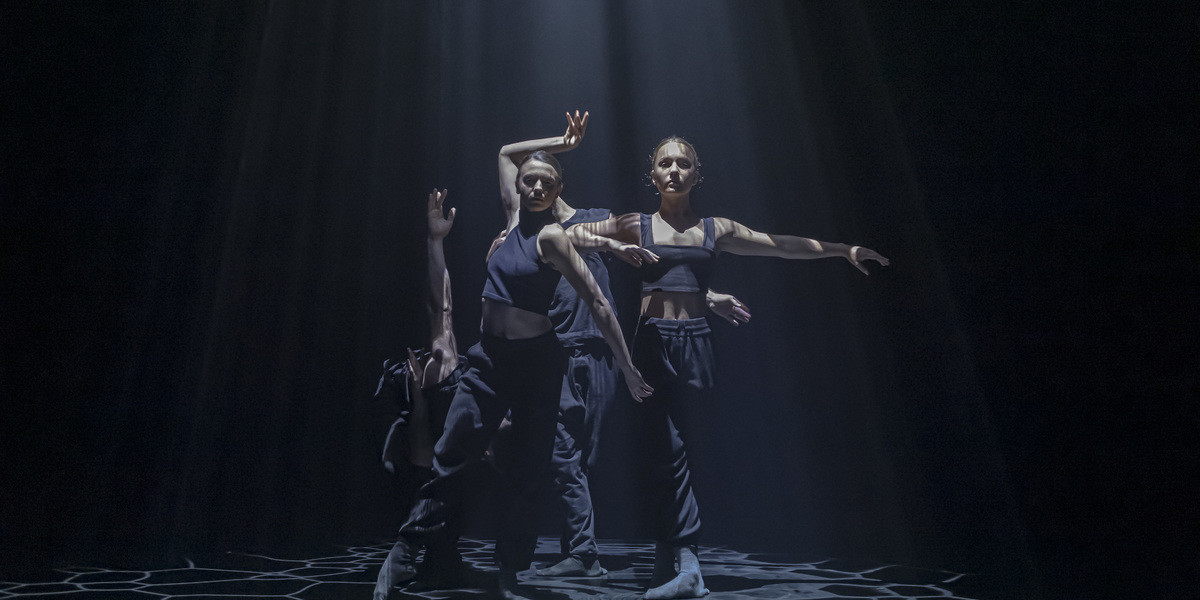 Maliphant x Major - two female dancers in brown costume performing the work two by russell maliphant in an otherwise black theatre