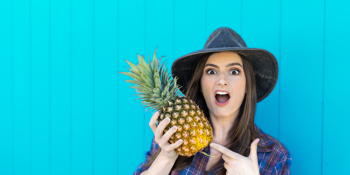 Laura Rose BUSHPIG - Farming girl wearing a cowboy hat holding a pineapple
