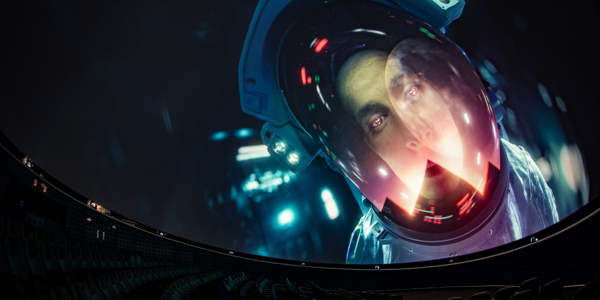 An astronaut looks over planetarium