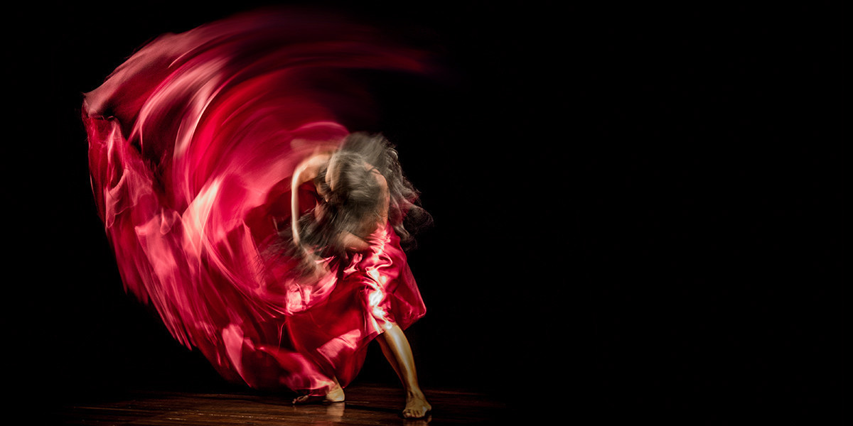 woman whirling a red fabric