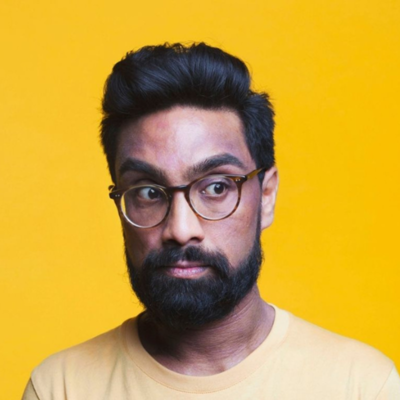 Suren Jayemanne looking off camera while wearing yellow shirt with yellow background