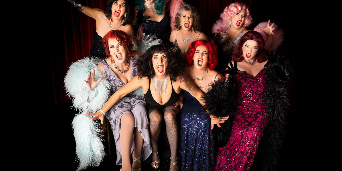 8 women in sparkly evening gowns screaming at the camera