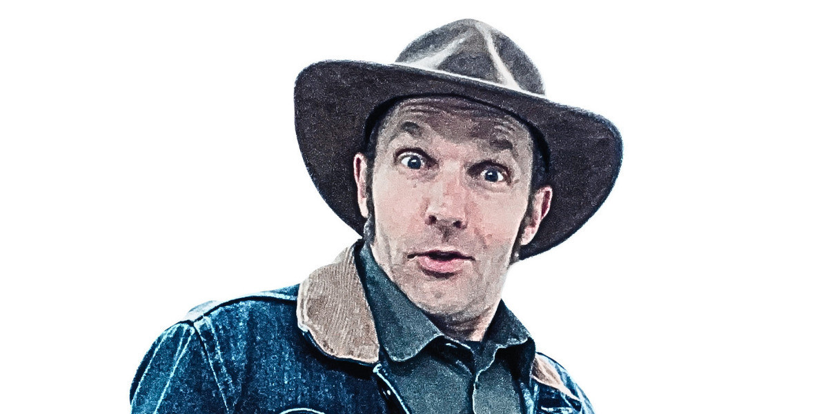 a man wears a cowboy hat and denim jacket.