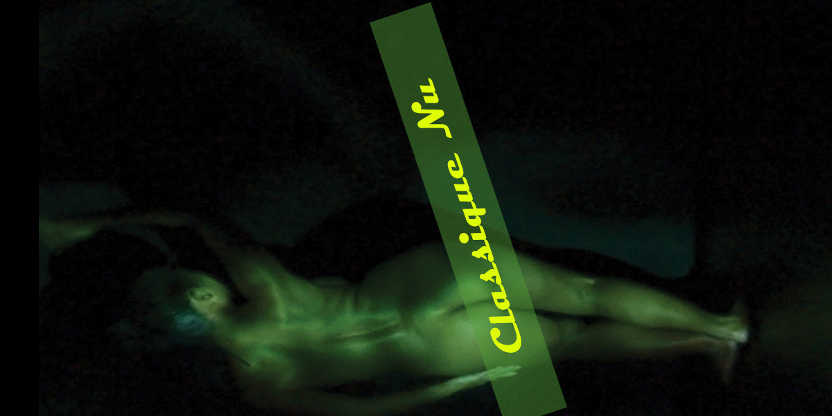 Woman bathed in green light lying down sideways with her back and buttocks facing you.