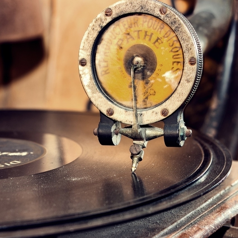 A Touch of Nostalgia and Romance - The image shows a gramophone and vinyl record from earlier days, playing music from the great performers.