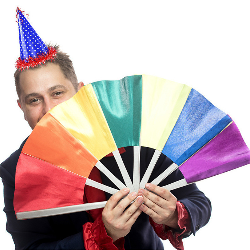 Mickster The Trickster holding a colourful fan and he is wearing a cute little party hat.    He is ready for his birthday for everyone to attend.