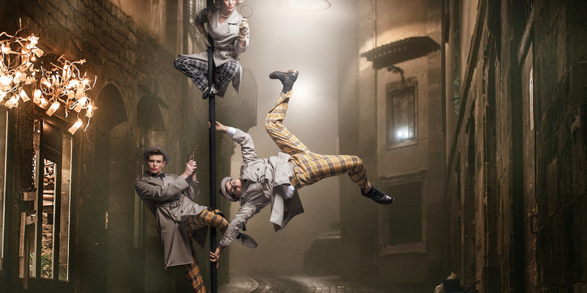 three circus artists on a Lamp post