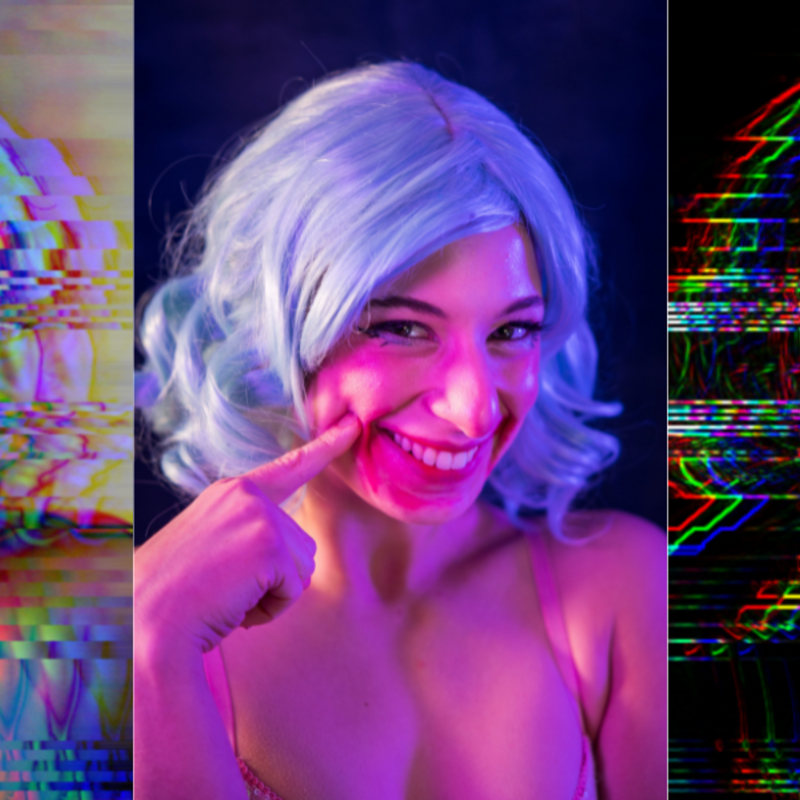 Three images are repeated side by side of a woman in a blue wig, smiling suggestively and poking a finger into her dimple. The middle image is untouched but the left and right are distorted, wavy and taking all the colour away from the woman, leaving her silhouette colourful and harsh.