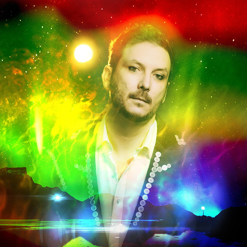 A man wearing a suit jacket with a foggy rainbow filter accross the image.