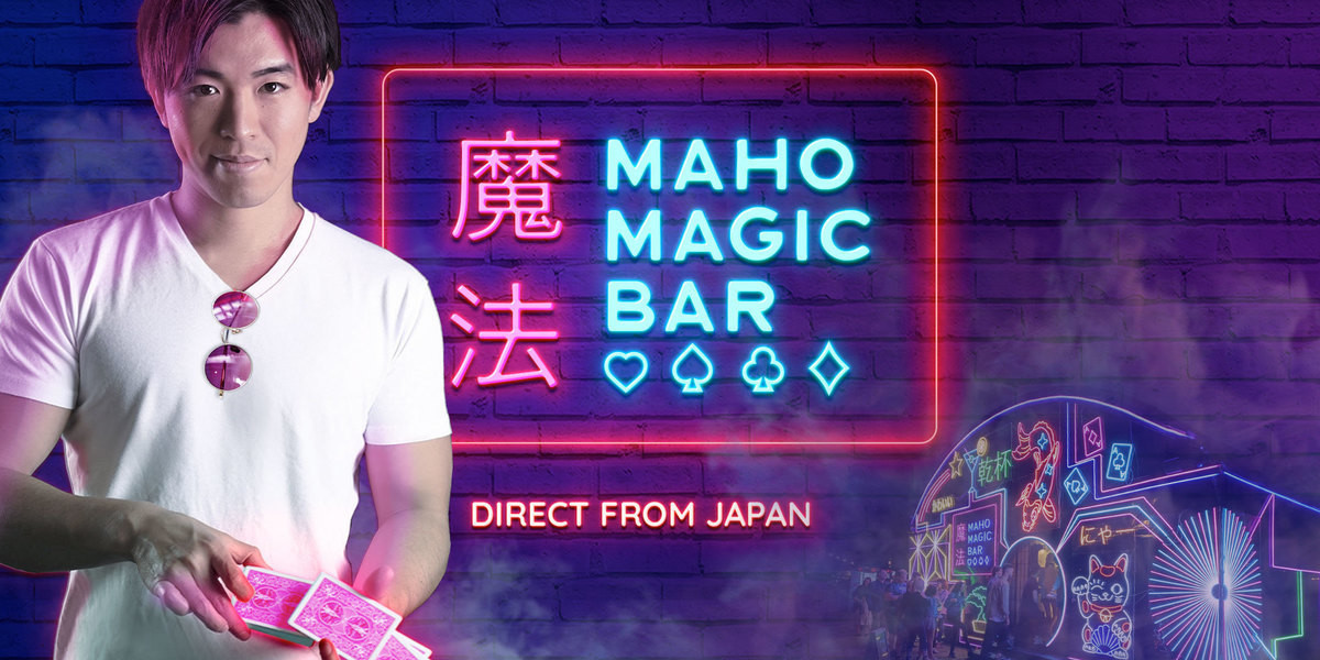Maho Magic Bar - A Japanese magician in a white shirt holding playing cards
A venue with neon art work in in the background
The words "Maho Magic Bar", kanji, and playing card symbols are in neon in the centre of the image.