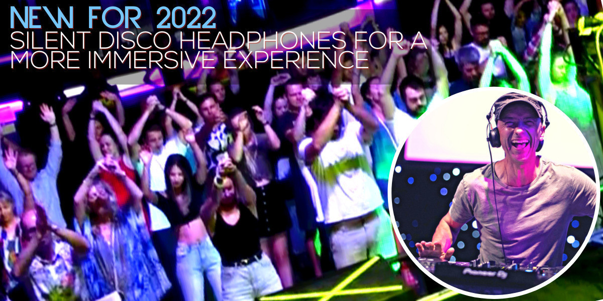 Crowd on dance floor with hands in the air.small picture overlay of Matt Hale wearing a cap and headset, smiling.