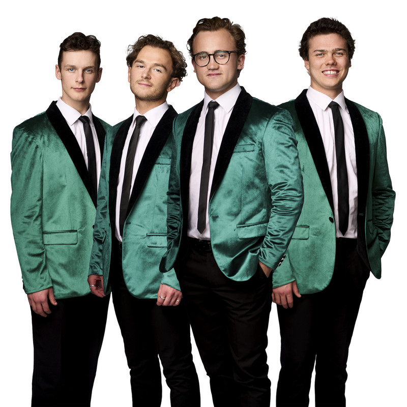 Four young men - Finnegan Green, Kyle Hall, Ben Francis and Lachlan Williams (L-R) - look forward, wearing matching green velvet suit jackets.