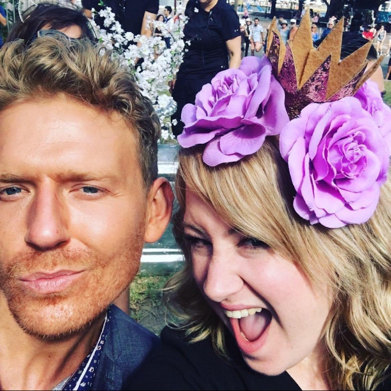 Jacob Stanley and Rosie Waterland take a 'selfie' together. On the left Jacob Stanley wears a navy blue shirt, on the right, Rosie Waterland wears a headband with purple flowers and a black shirt.