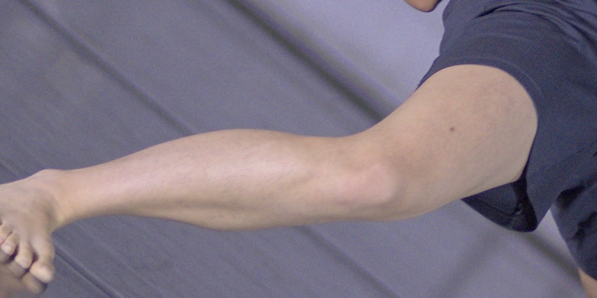 A dancers leg takes up the full frame of the photo
