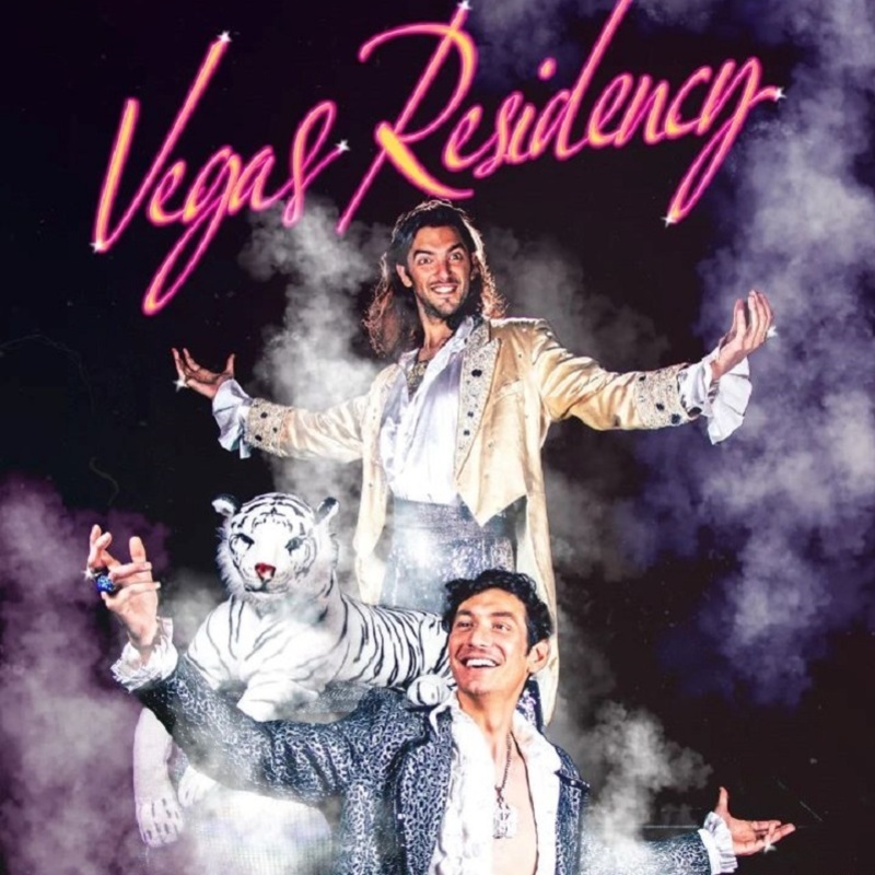 Vegas Residency - Two men stand with arms extended with a large stuffed tiger, hazy smoke and the words 'Vegas Residency' above them.