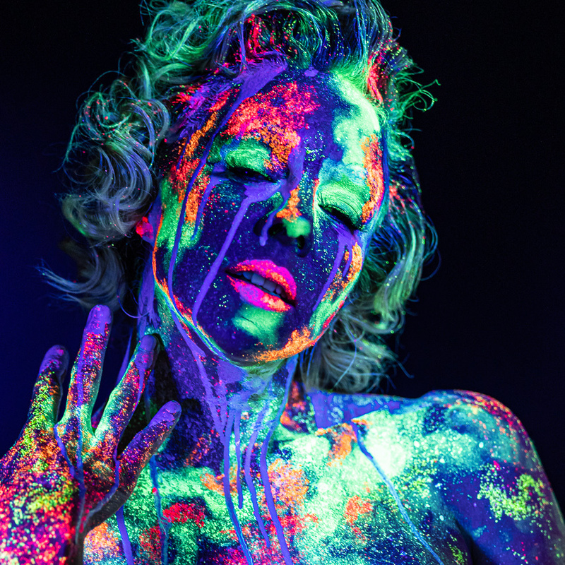 Photograph by Leslie Liu of Imogen Kelly seductively covered in UV paint.