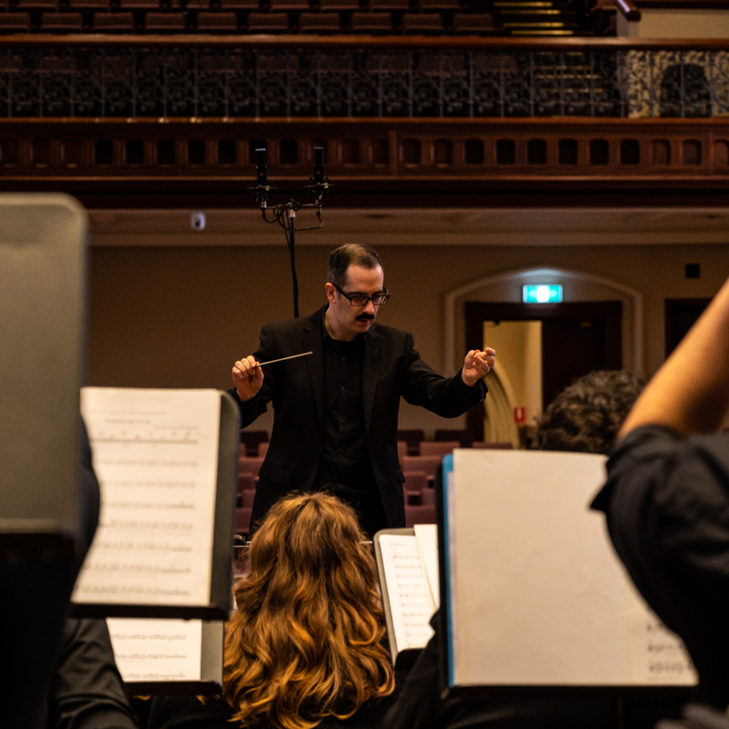 Bryan Griffiths conducting Adelaide Wind Orchestra from the perspective of inside the ensemble