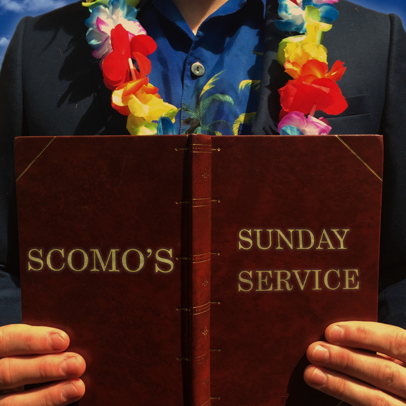 Scomo's Sunday Service - A photo of a person holding a brown leather book that reads, ‘Scomo’s’ and ‘Sunday Service’ on either cover in gold lettering. The person holding the book is wearing a black jacket, blue shirt and rainbow Hawaiian flower lei.