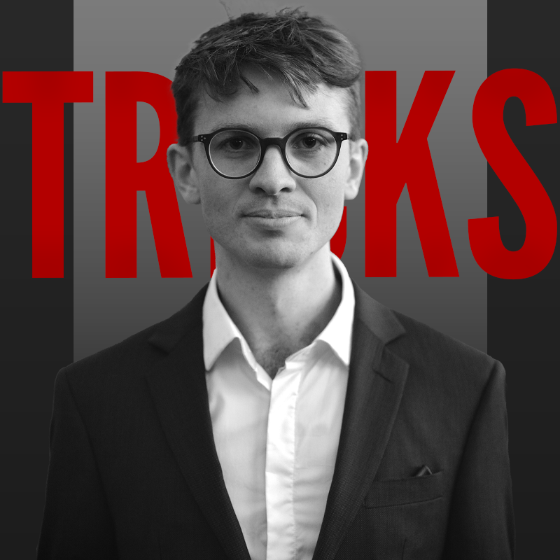 A black and white headshot of Sam standing in front of red text that says "Tricks"