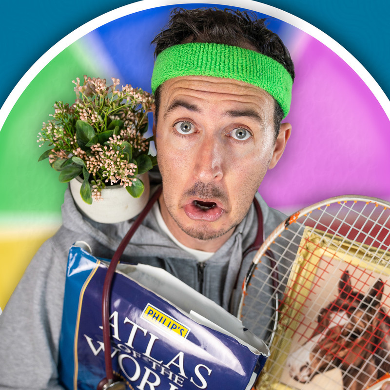A man in a grey tracksuit top, wearing a green headband, looks up at the camera with a shocked and surprised expression. He has a pot plant on his shoulder, he is carrying a tennis racquet, an atlas and a painting of a horse. The background are the colour wheel pattern of the Trivial Pursuit board