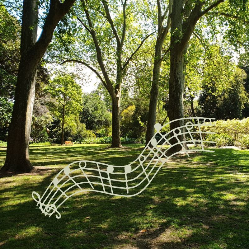 Garden Melodies - Music notes over a garden