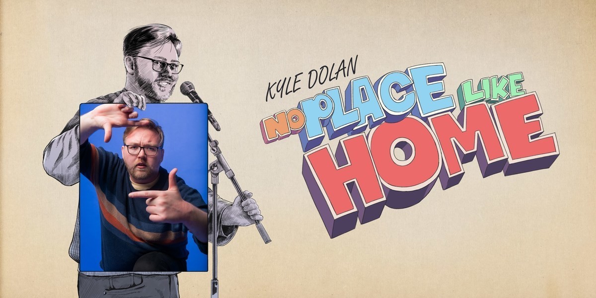 Kyle Dolan - No Place Like Home - a comedian stands with microphone in hand, gesturing. There is a red hue to the image