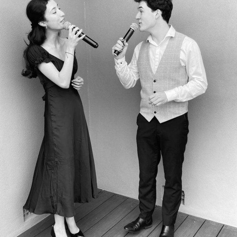 A woman and man singing to each other