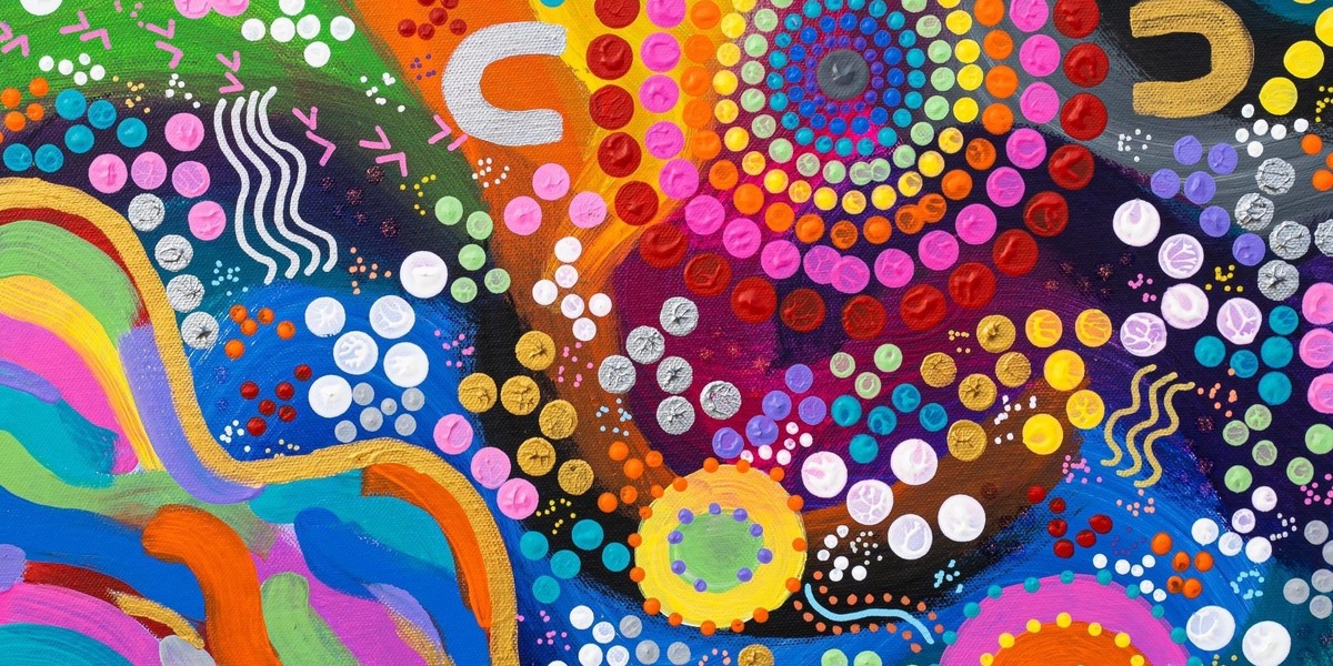 A detailed shot of a rainbow dot painting.
