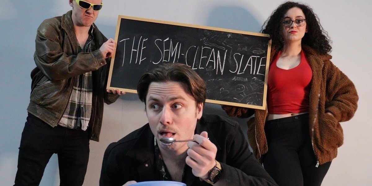 Three members of the cast, two holding a blackboard reading "The Semi-Clean Slate", the other having a bowl of Chex Cereal.