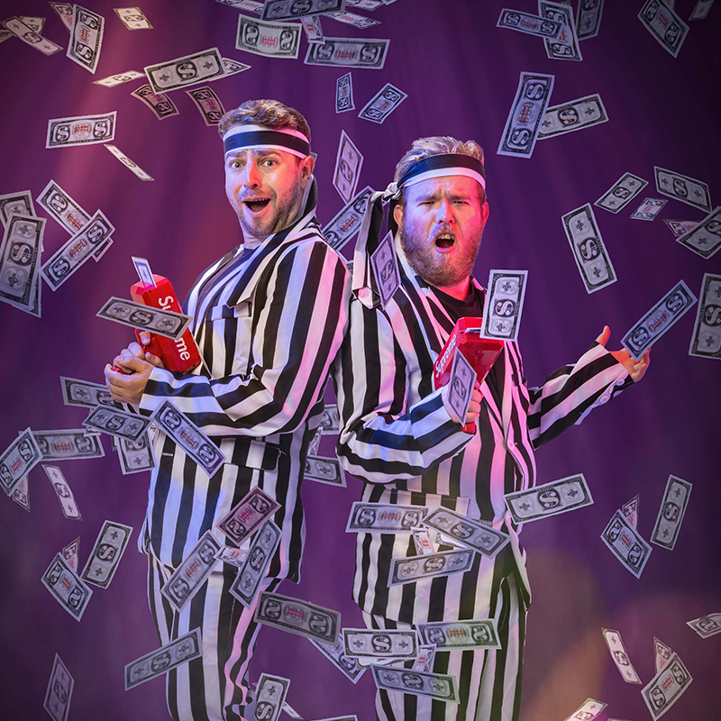 Late Night Party Boyz Do a Legally Mandated Kids Show - Two boys wearing stripey suits shoot money guns and look surprised