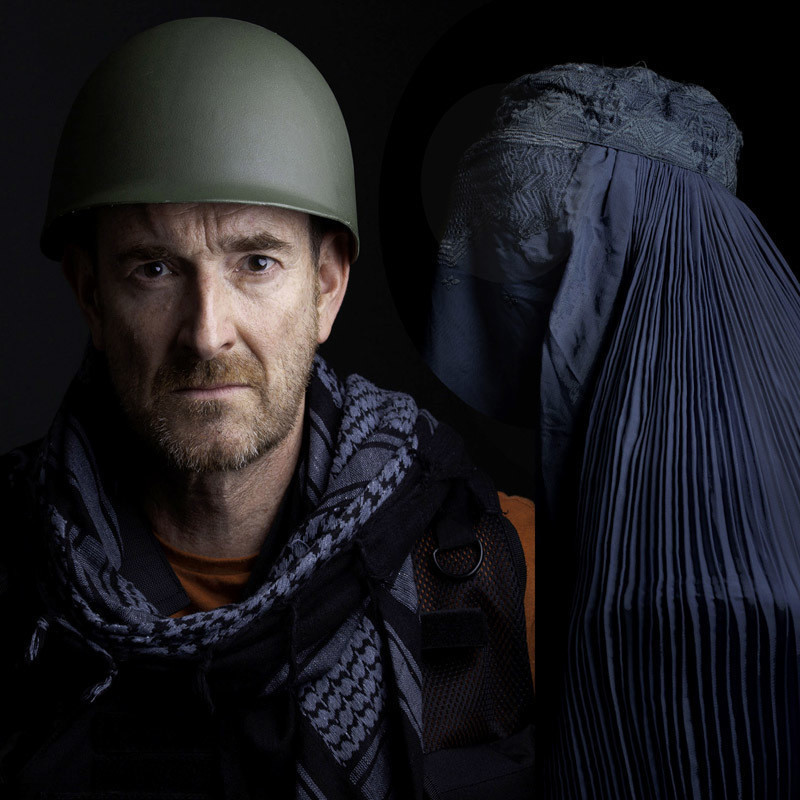 AFGHANISTAN IS NOT FUNNY by Henry Naylor - Henry Naylor faces front and a woman in a blue Afghani Burqa speaks into his ear