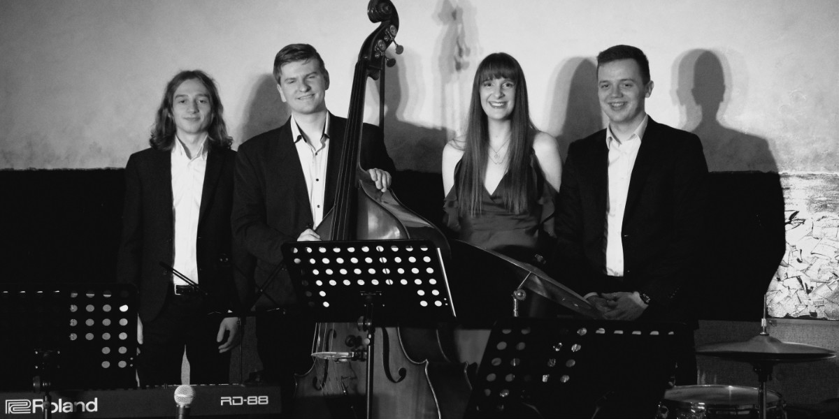 Four performers smile after a performance. Left to Right: Edmund Black, Dan Courts (and his double bass), Tiffany Gaze and Jack Barton.