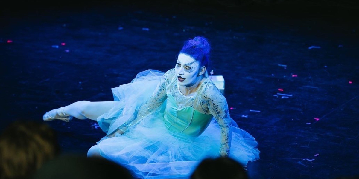 A ballerina who has fallen on stage