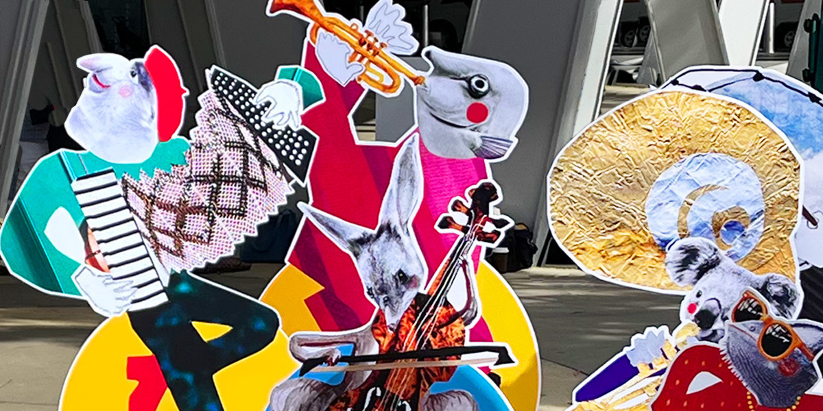 Large cut out sculptures of Rebecca's character illustrations including: a proboscis monkey playing the accordion, a bilby playing the cello, a trumpeter with a fish head, a koala playing the tuba and a chameleon on bongo drums.