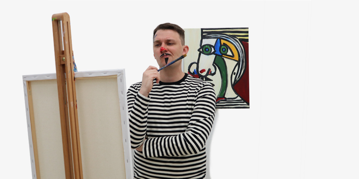 A painter in a black and white striped shirt, with red paint smeared on his nose like a clown, a drawn-on, black triangular moustache and goatee, and blue paint smeared on his forehead stands contemplating what to paint behind a blank canvas on an easel. He is holding a paintbrush against his chin as if he is thinking. Behind the artist is a parody of a Picasso style cubist portrait, featuring the artist's face.