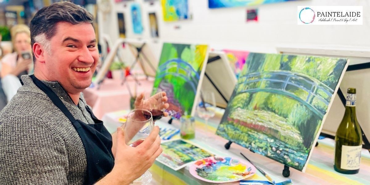 A Fringe Special Paint & Sip - Van Gogh, Monet, Picasso and Travel Themes - Person posing with a glass of wine and his finished painting at Paintelaide's paint and sip studio