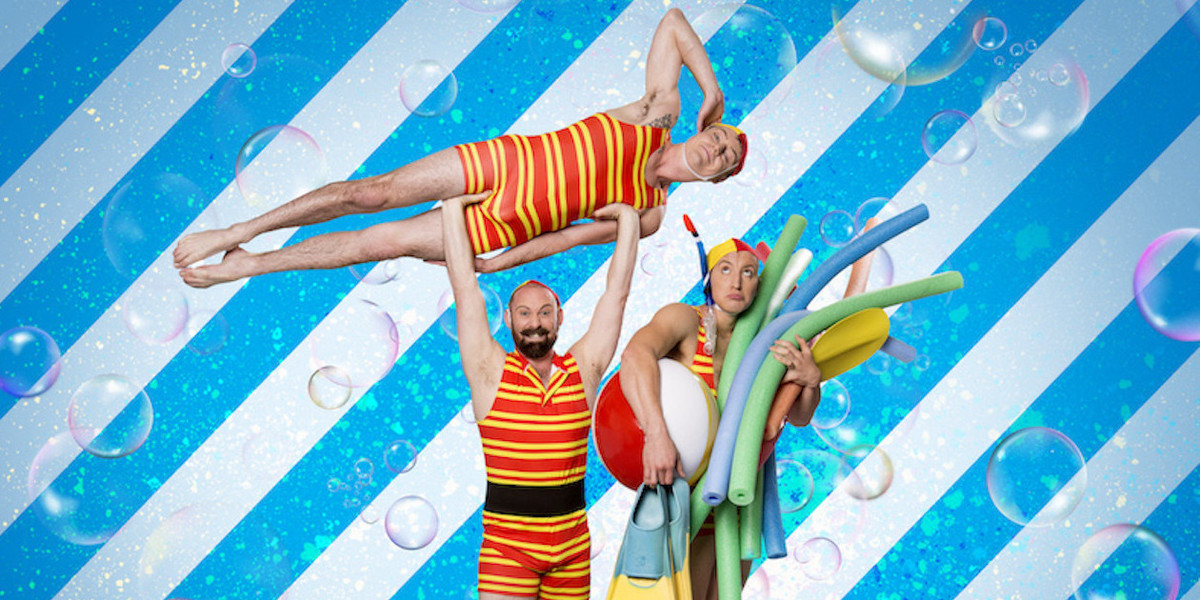 three men performing acrobatic stunt while while in bathing outfits